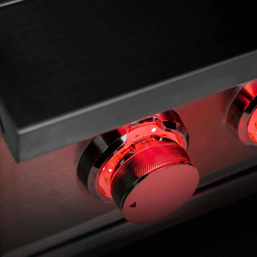 Side burner control knob with red indicator and textured grip on stainless control panel
