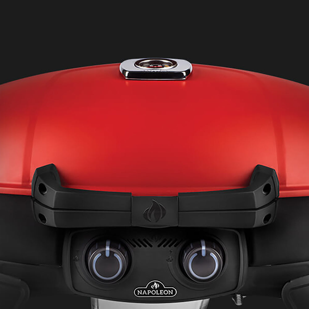 Front view of portable gas grill with red lid, black control panel and two knobs
