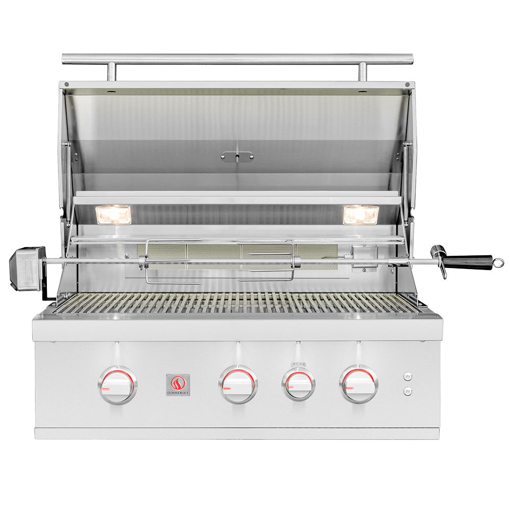 Stainless built-in gas grill with open lid showing burners and front control knobs