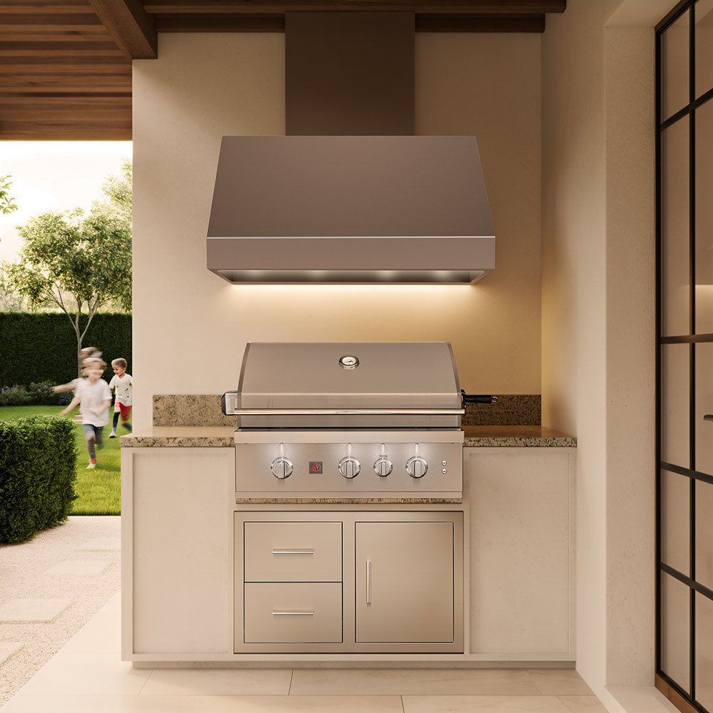 Built-in stainless gas grill installed in an outdoor kitchen with side storage