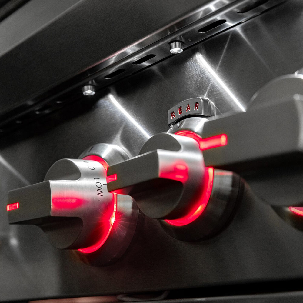 Gas grill control knobs and ignition area with red indicator lights