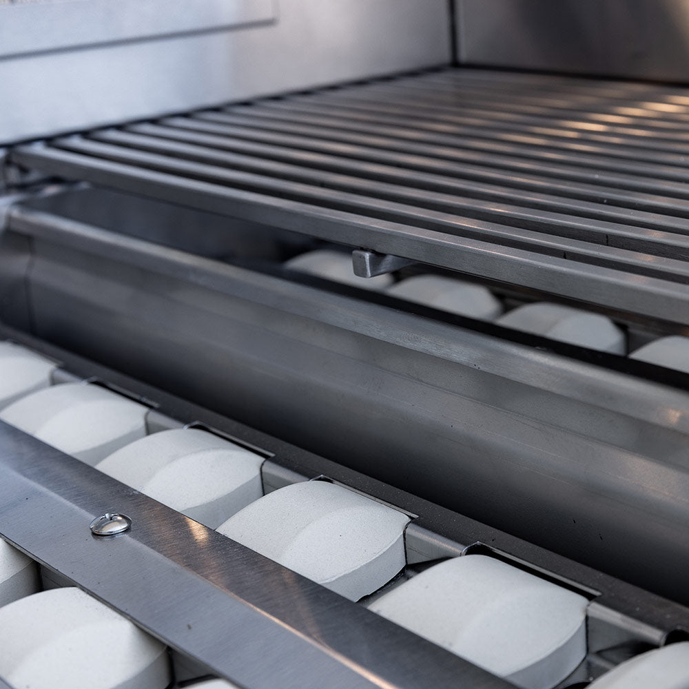 Stainless grill burner bars beneath the cooking grate