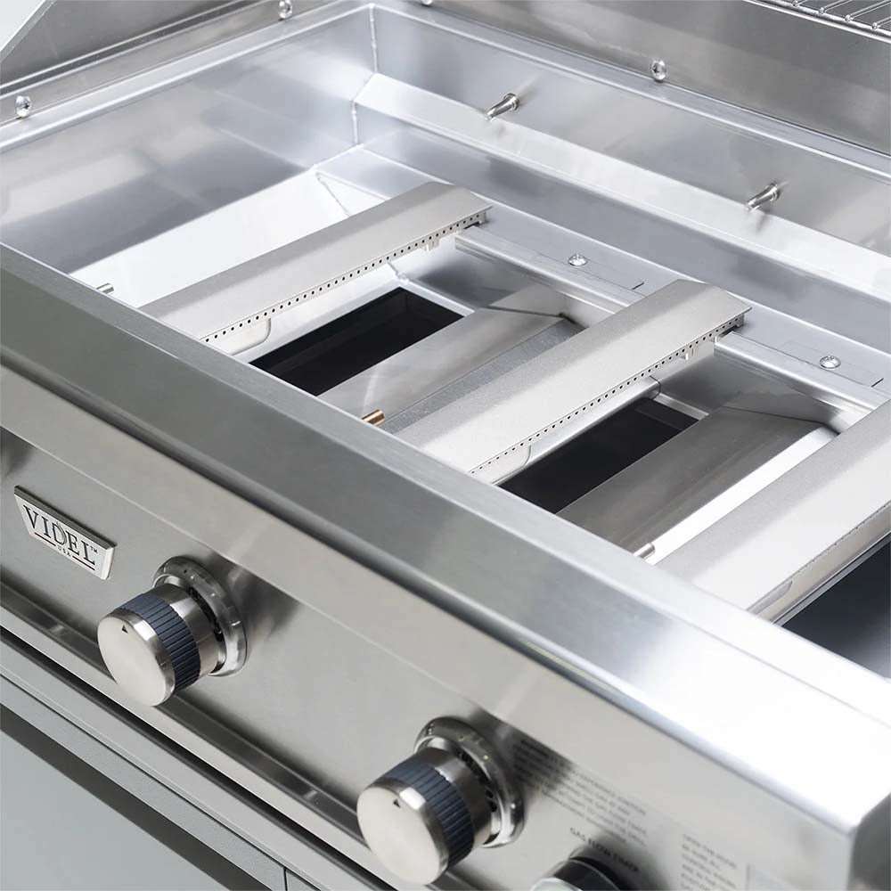 Stainless steel commercial gas grill interior with three burner grate sections