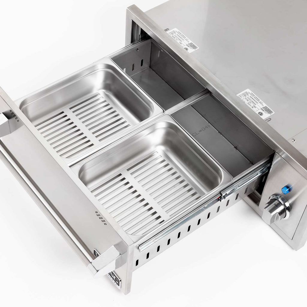 Stainless steel warming drawer interior with two basins and slatted heating inserts.