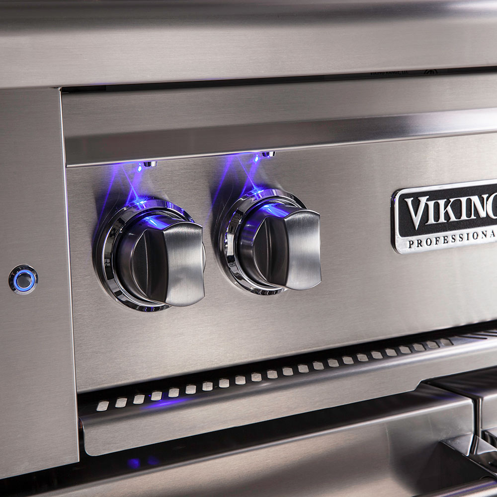 Stainless grill control panel with blue-lit knobs and Viking Professional badge.