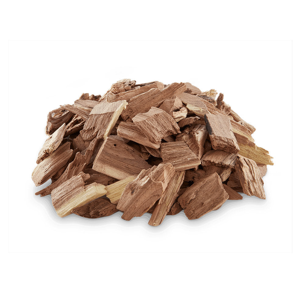 Mesquite wood chips pile of small light-brown wood pieces