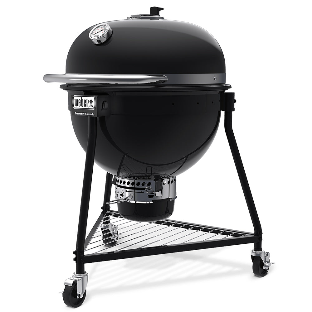 Black kamado-style charcoal grill with domed lid closed on a wheeled metal stand.