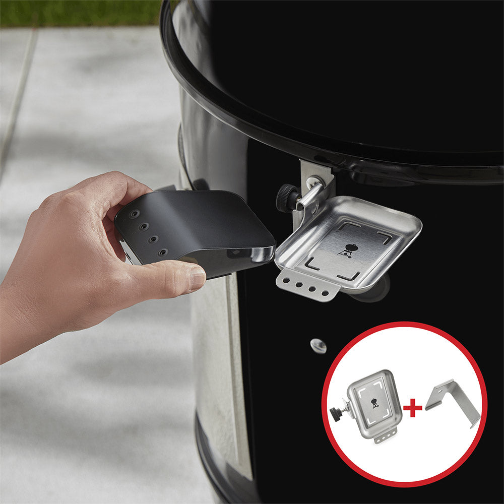 Hand installing dark mounting bracket on grill with metal plate and screws