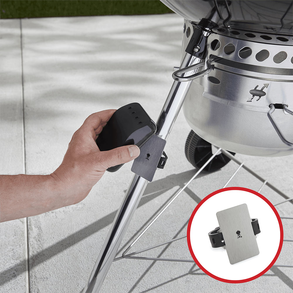 Hand mounting dark bracket to grill leg with metal attachment plate