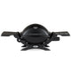 Black portable propane grill with lid closed, side tables, and burner controls