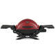 Portable propane grill with side tables, red lid and black base
