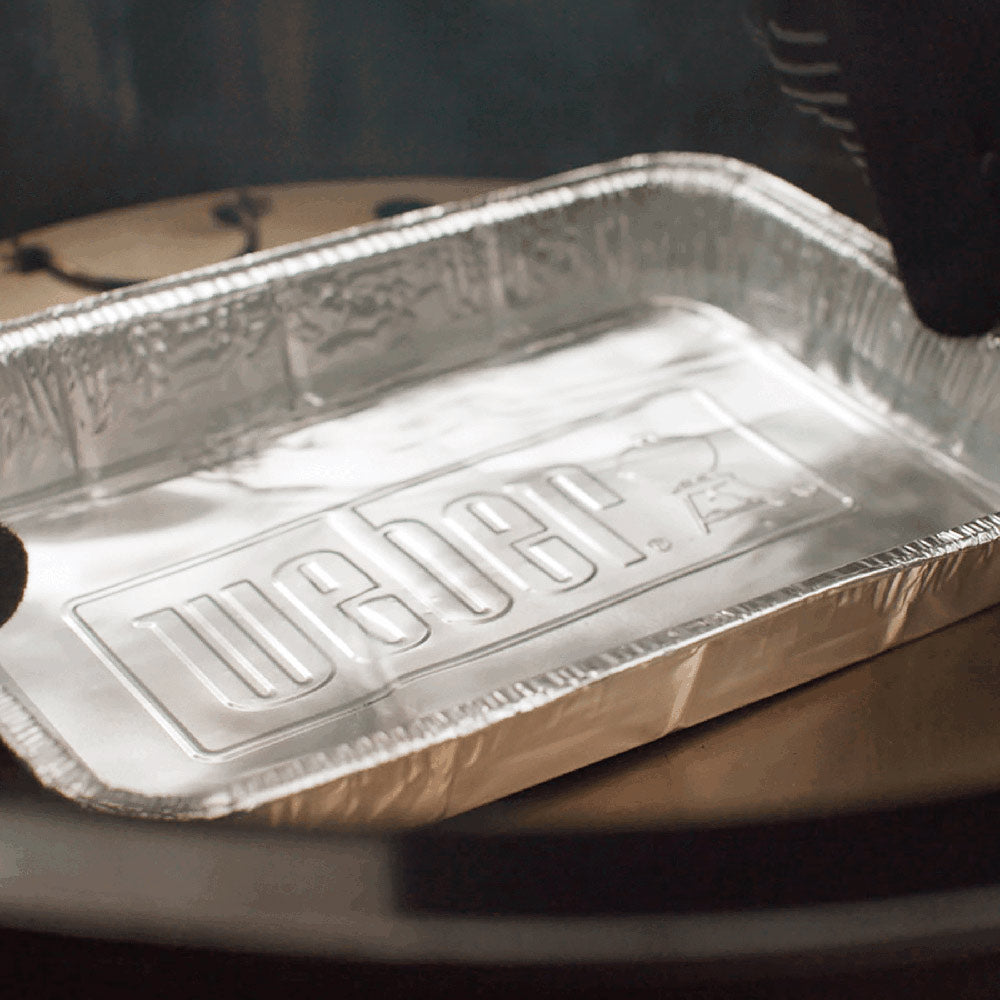Aluminum drip pan tray close-up with embossed pattern on the base, disposable