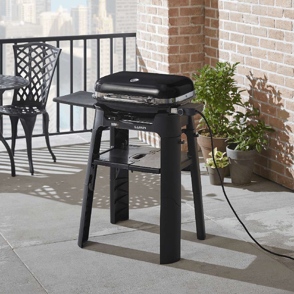 Weber Lumin grill stand with side table, black grill on frame and lower shelf