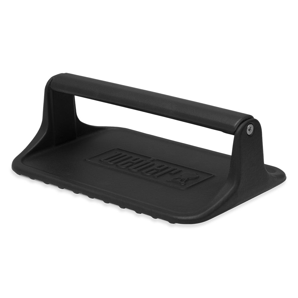 Black griddle press with handle and raised ridged plate