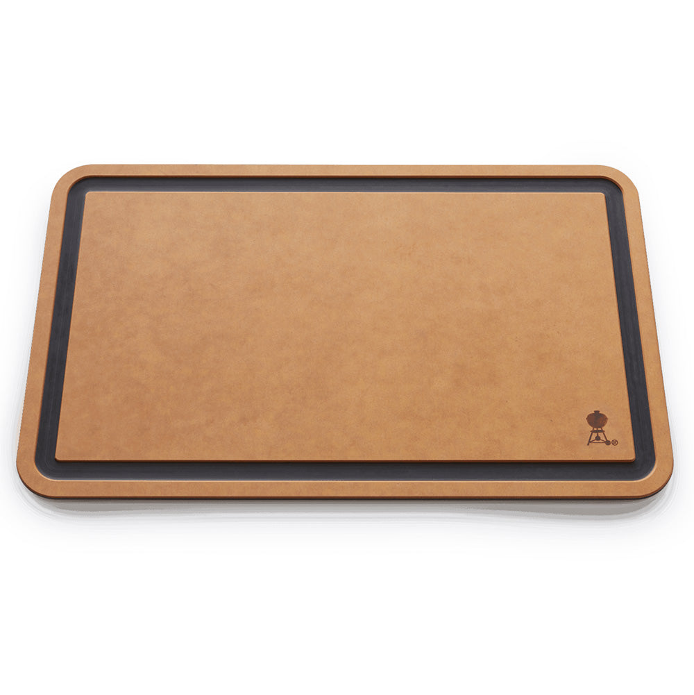 Weber cutting board with tan surface, dark frame border, corner hanging icon