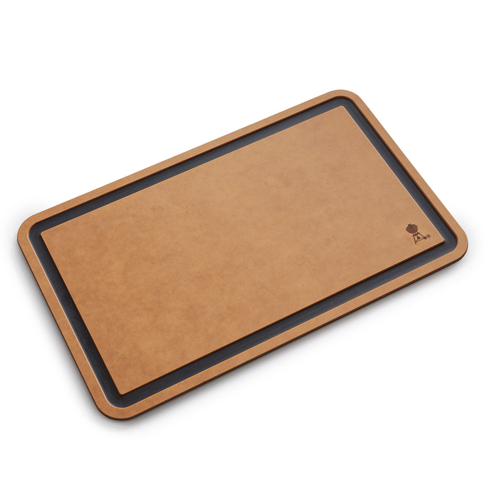 Weber cutting board with tan surface, dark border, corner grill icon