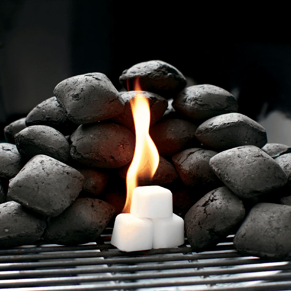 Weber lighter cubes burning in charcoal, flames between cubes