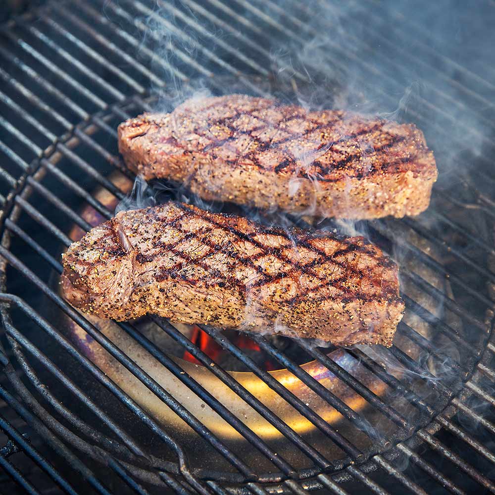 Weber charcoal heat controller, two pork chops on hot grill grates