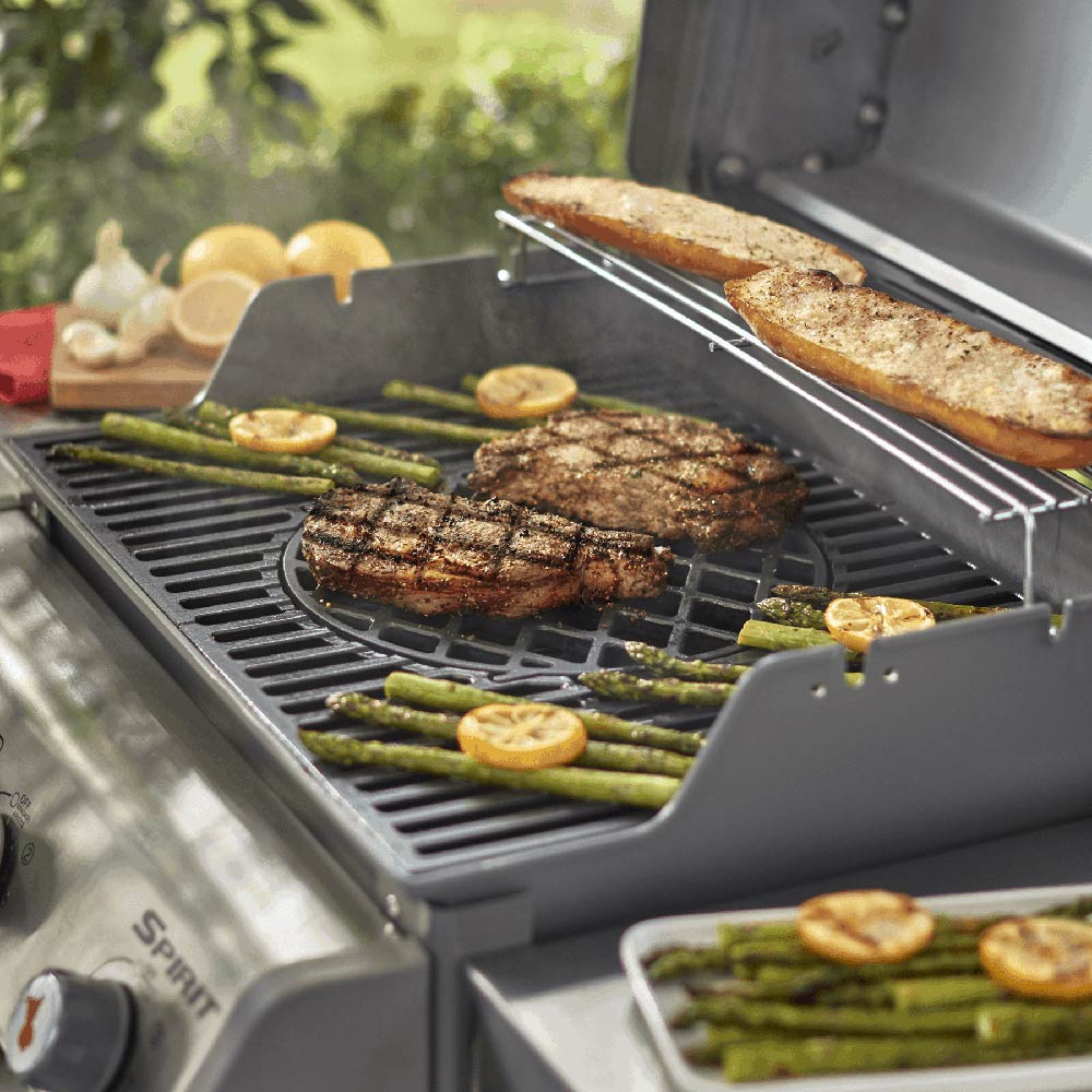 BBQ sear grate with grilled steak and vegetables on raised grill surface