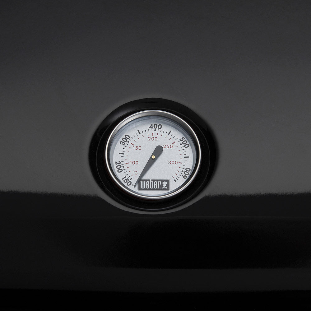 Temperature gauge dial on Weber Lumin electric grill housing