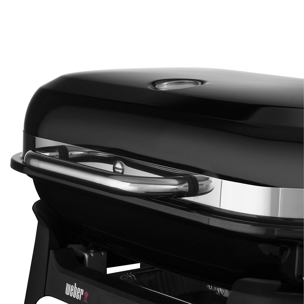 Lidded Weber Lumin portable electric grill with chrome handle detail