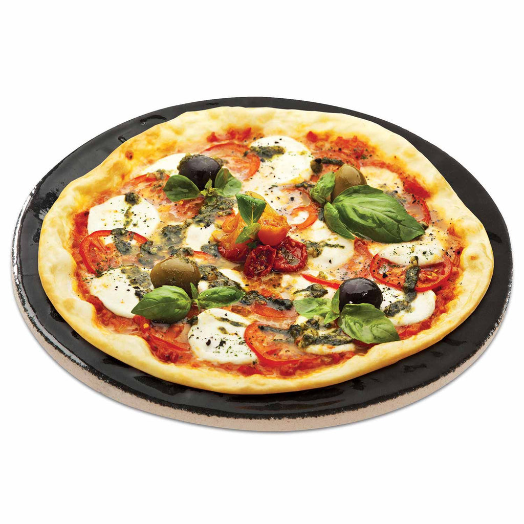 Round porcelain glazed pizza baking stone with topped pizza, 16-inch