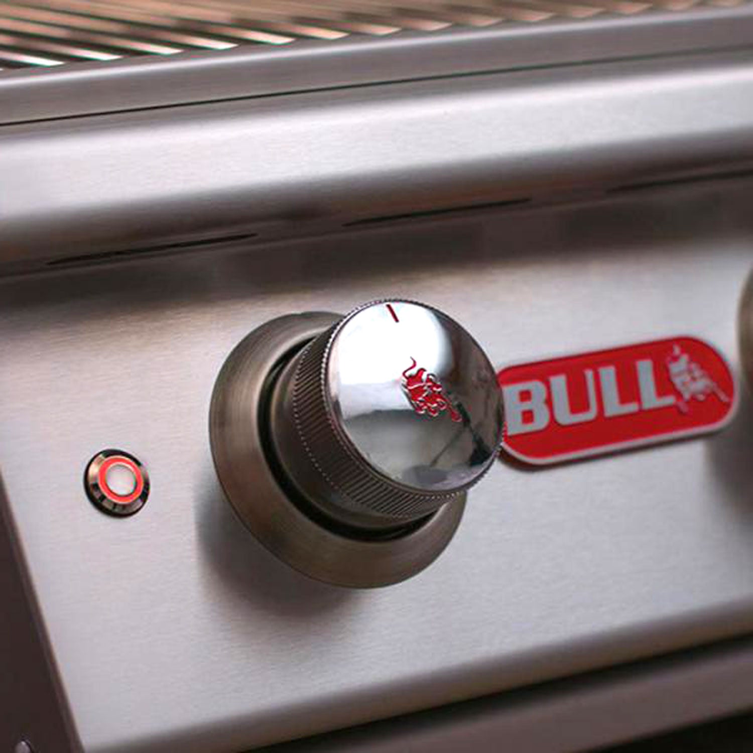 Stainless steel control knob and Bull-branded label on gas grill panel