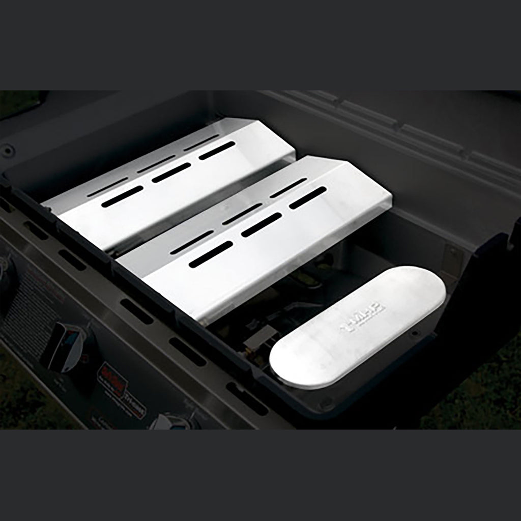 Built-in gas grill interior with stainless cooking grates and side warming tray