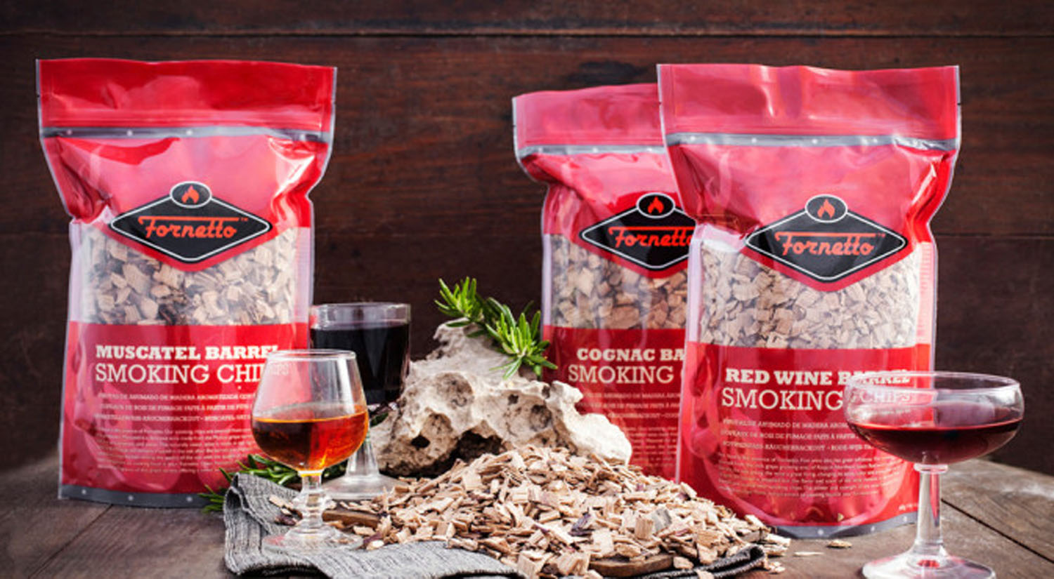Fornetto smoking wood chips pouches with scattered wood chips, on a wooden surface