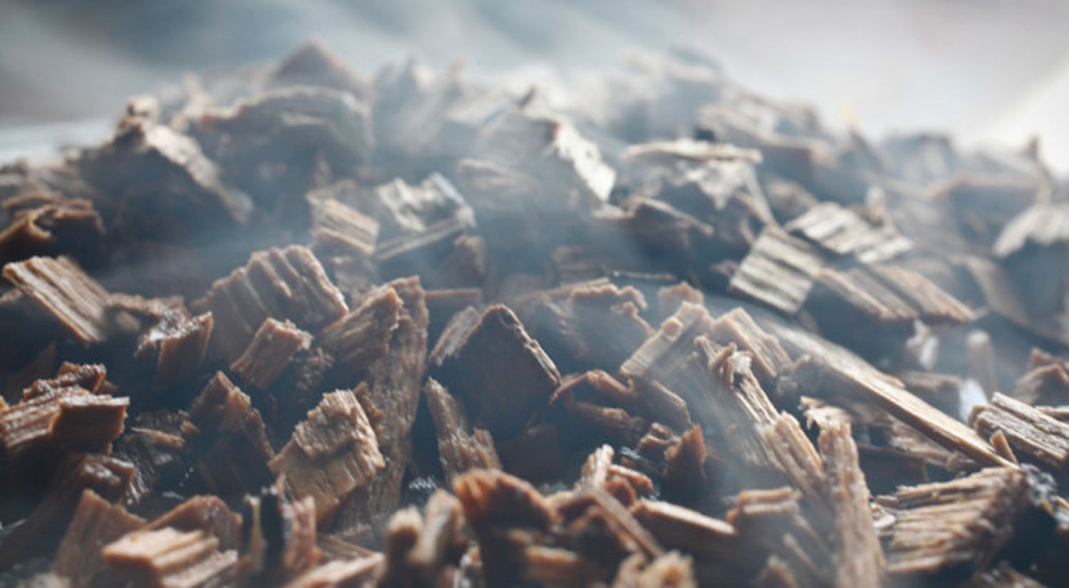 Pile of smoking wood chips, close-up