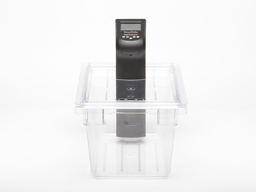 Immersion circulator placed in a clear plastic container with control panel