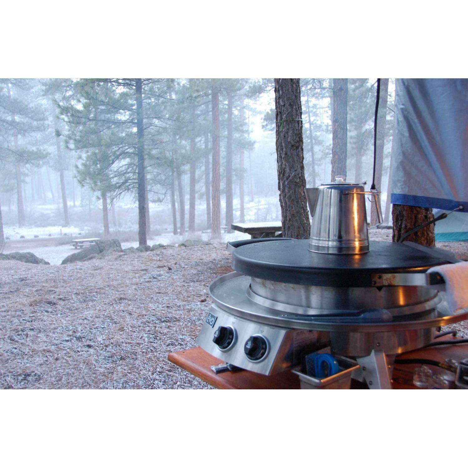 Tabletop gas grill with black lid and stainless body; front control knobs visible