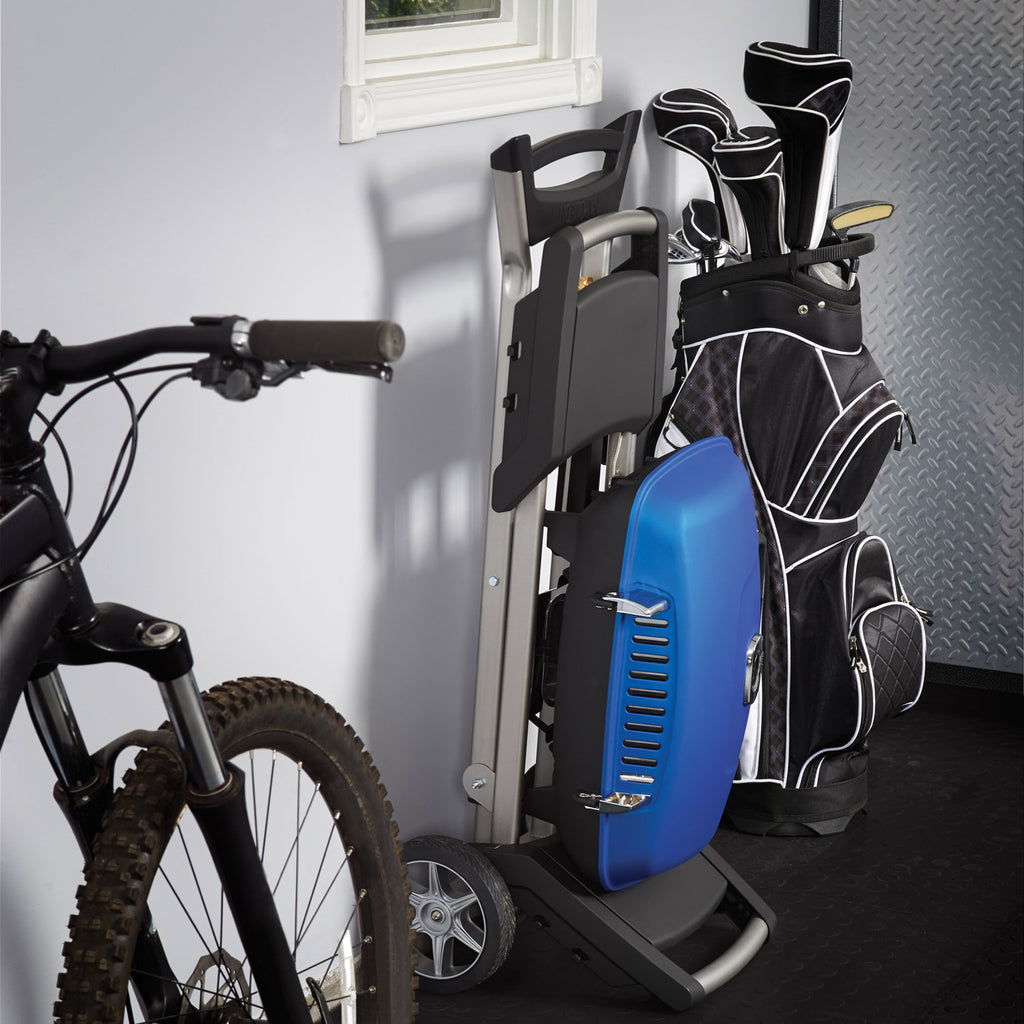 Portable propane grill on cart with blue side panel next to storage bags and tools