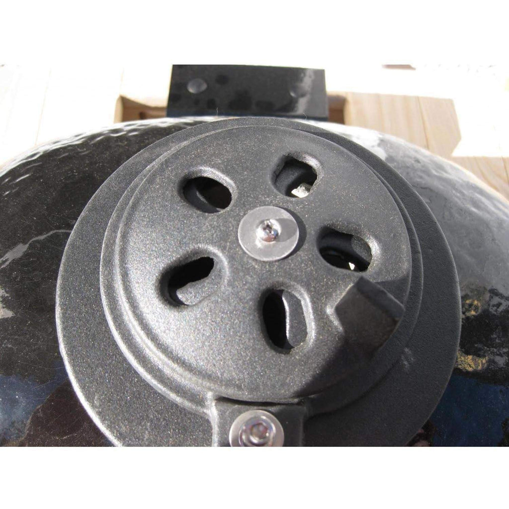 Black ceramic kamado grill lid vent with adjustable openings and center control knob